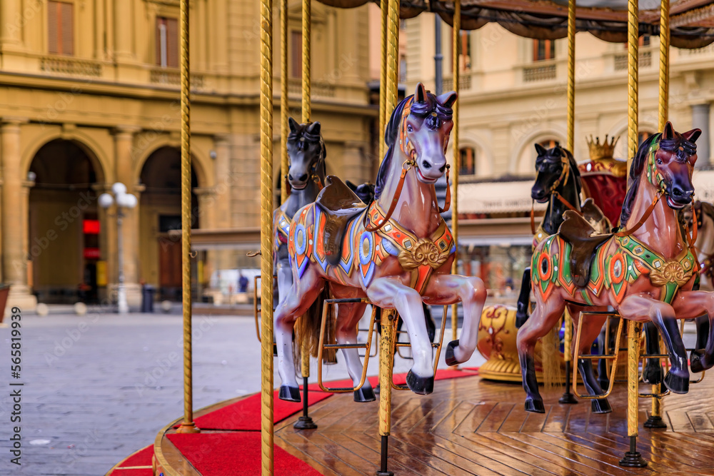 Antique carousel with wooden horses on Piazza della Republica Florence, Italy