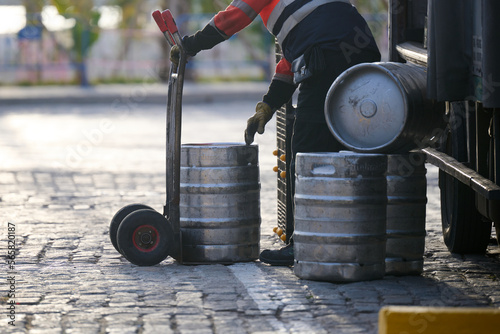Man delivering beer kegs in Malaga, Spain