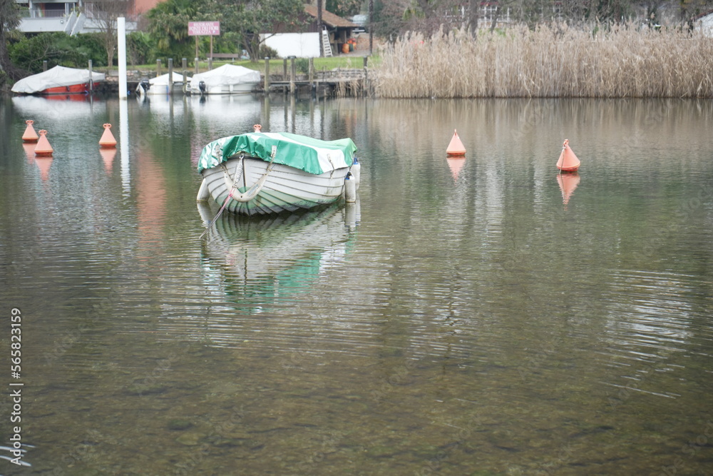Obraz premium Boat on the lake in Lavena Ponte Tresa, Province of Varese, Italy