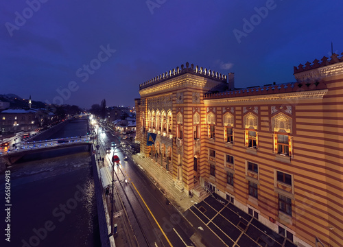 Sarajevo city hall or national library in town center aerialhyper lapse or time lapse. Landmark in capital of Bosnia and Herzegovina covered with fresh snow in the winter season at night. 