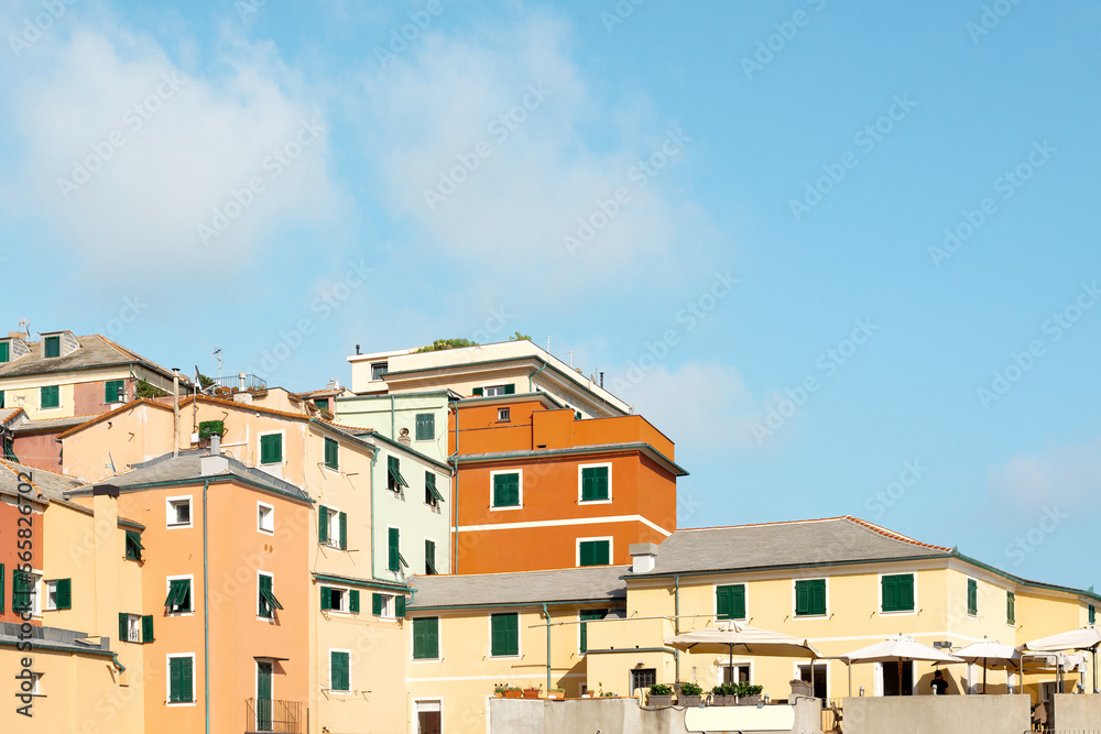 Traditional European architecture in old mariners' village Boccadasse, Italy. Colorful old buildings on a blue sky background