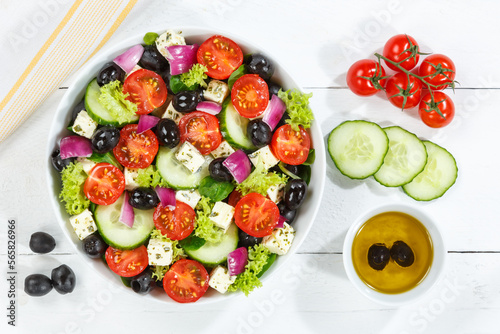 Greek salad with fresh tomatoes olives and feta cheese healthy eating food from above on a wooden board