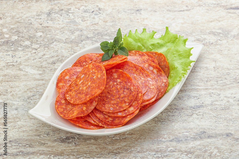 Sliced pepperoni sausage in the bowl Sliced pepperoni sausage in the bowl