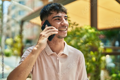 Young hispanic man smiling confident talking on the smartphone at street © Krakenimages.com