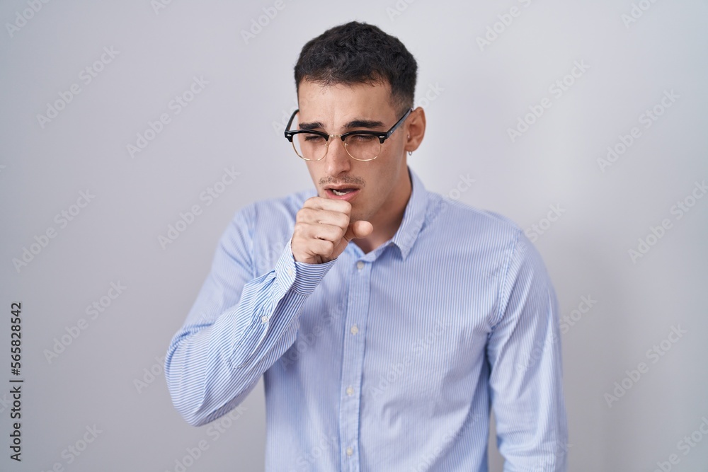 Handsome hispanic man wearing business clothes and glasses feeling unwell and coughing as symptom for cold or bronchitis. health care concept.