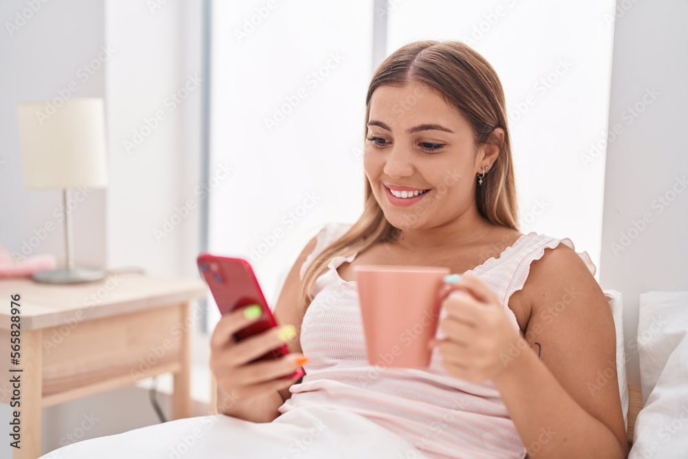 Young beautiful hispanic woman using smartphone drinking coffee at bedroom Young beautiful hispanic woman using smartphone drinking coffee at bedroom