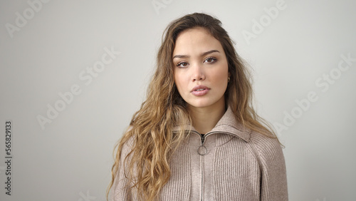 Young beautiful hispanic woman standing with relaxed expression over isolated white background