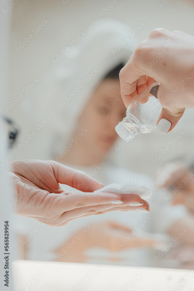 custom made wallpaper toronto digitalAfter showering the body and head wrapped in a towel, women's hands apply a moisturizing skin lotion to a cotton pad to wipe the face.