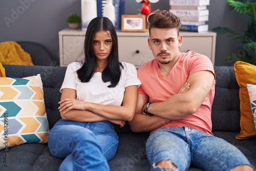 Man and woman couple in disagreement sitting on sofa at home