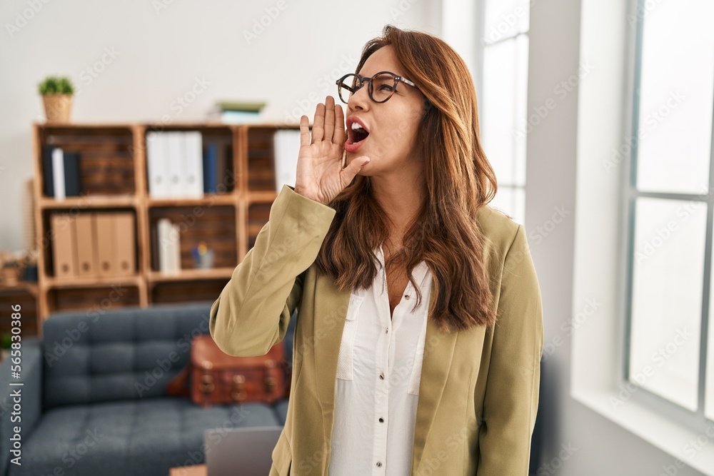 Hispanic woman working at consultation office clueless and confused with open arms, no idea and doubtful face. Hispanic woman working at consultation office clueless and confused with open arms, no idea and doubtful face.