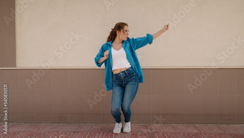 Young woman smiling confident dancing at street