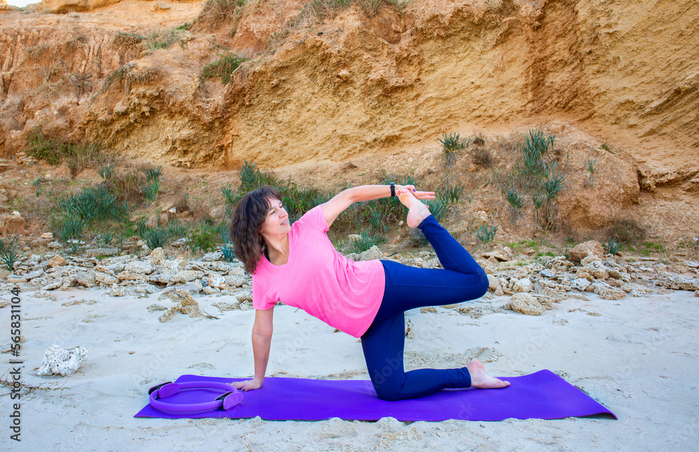 Woman doing yoga on a beach