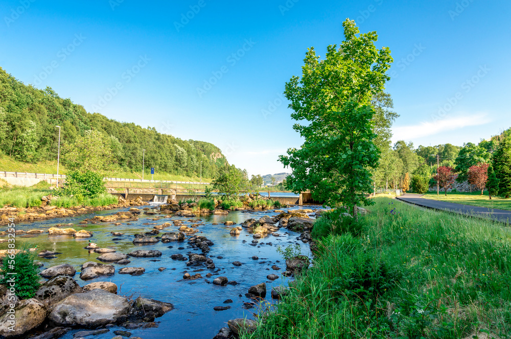 A walk path along scenic small river with rocks close to Algard town, Norway, June 2018