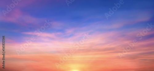 Real amazing panoramic sunrise or sunset sky with gentle colorful clouds. Long panorama, crop it. Evening sky scene with golden light from the setting sun © Gan