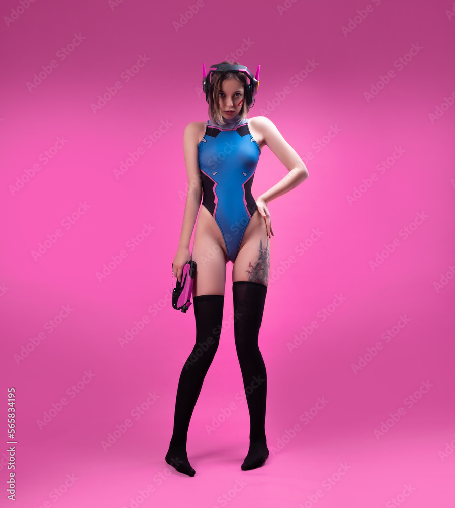 sexy gamer girl in a revealing bright bodysuit and gaming headset on a pink  background Stock-bilde | Adobe Stock