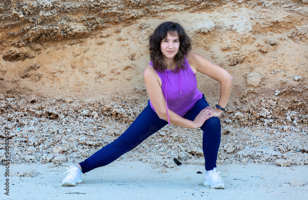 Woman doing yoga on a beach