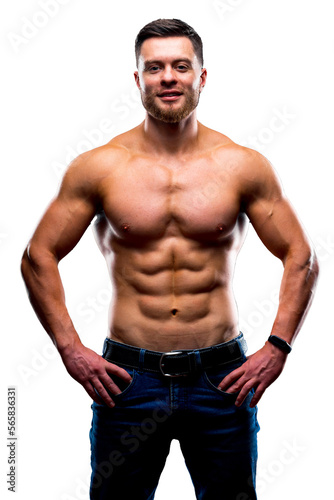 Muscular guy with naked torso posing with hands on waist. studio photo. Portrait of a handsome man in jeans.