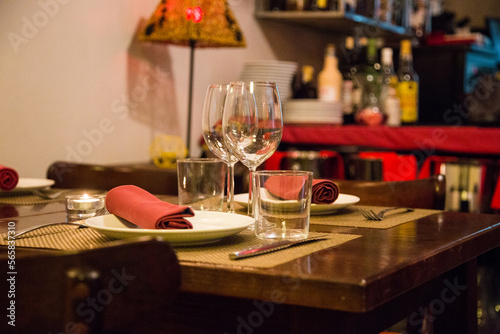 Elegant restaurant table with cutlery  crockery and glasses.