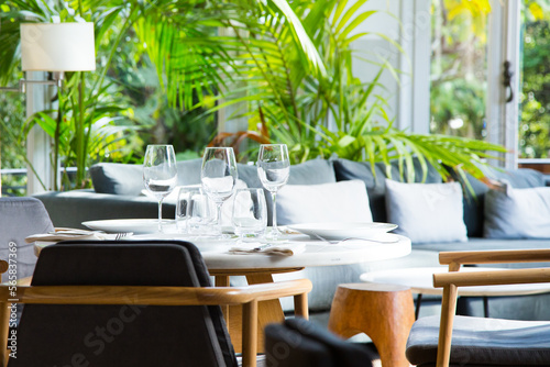 Elegant restaurant table with cutlery  crockery and glasses.