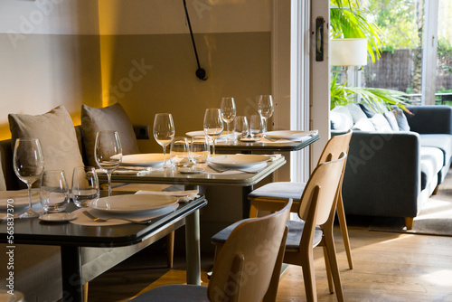 Elegant restaurant table with cutlery, crockery and glasses.