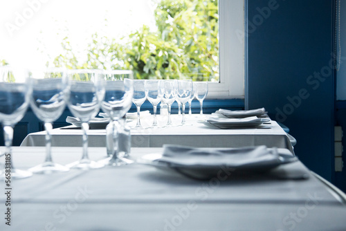 Elegant restaurant table with cutlery, crockery and glasses. © Leckerstudio