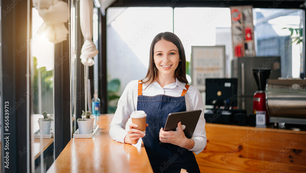 Young woman coffee shop owner holding notepad and digital tablet ready to receive orders. in cafe restaurant. Young woman coffee shop owner holding notepad and digital tablet ready to receive orders. in cafe restaurant.