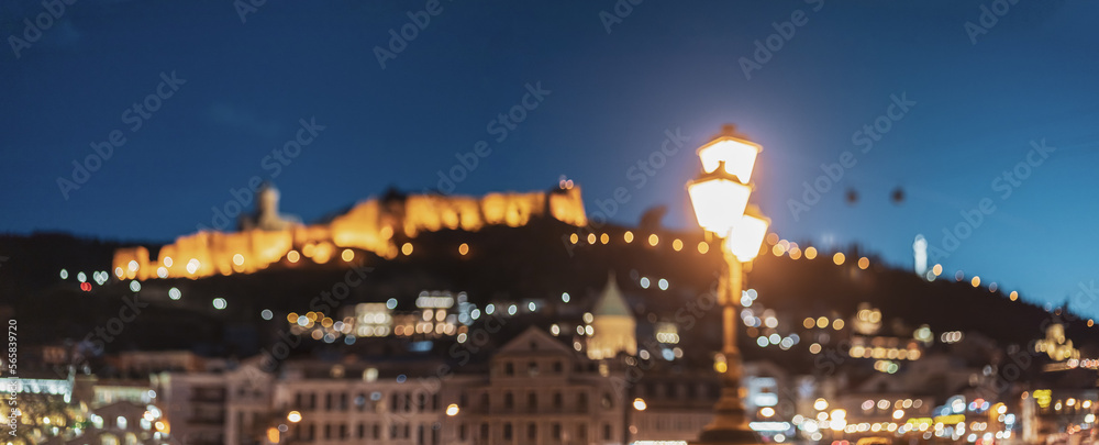 Tbilisi, Georgia Scenic Panoramic View Of Impregnable Fortress Narikala Fortress. Night Boke Bokeh Blurred Ancient Fortress Narikala In Old Town Of Tbilisi. Caucasus. Abstract Blurred Bokeh
