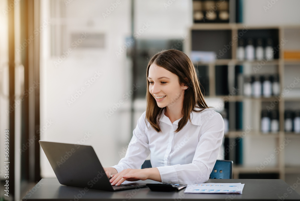 Confident Asian woman with a smile standing holding notepad and tablet at the modern office. Confident Asian woman with a smile standing holding notepad and tablet at the modern office.