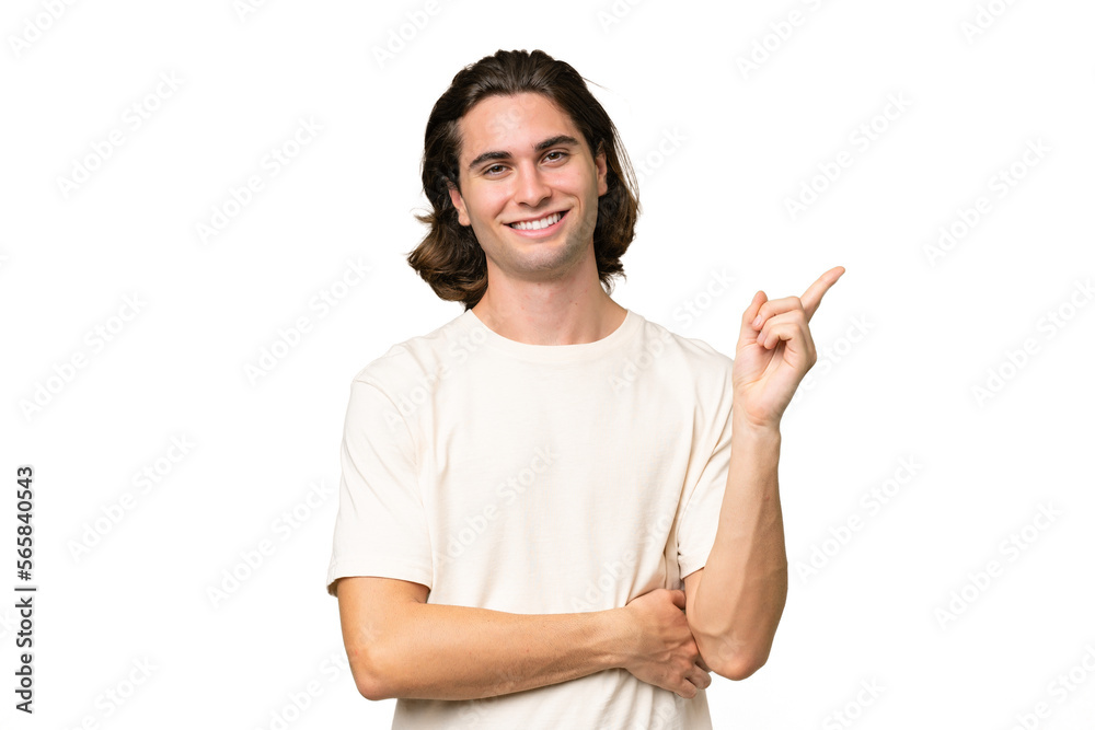 Young caucasian man isolated on green chroma background happy and pointing up Young caucasian man isolated on green chroma background happy and pointing up