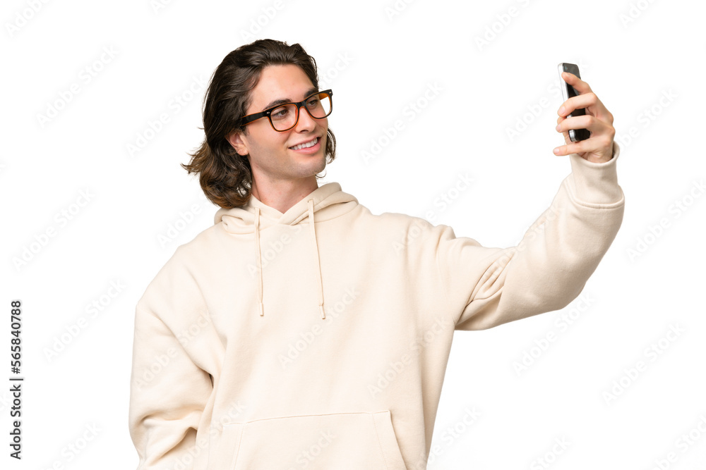 Young caucasian man isolated on green chroma background making a selfie Young caucasian man isolated on green chroma background making a selfie