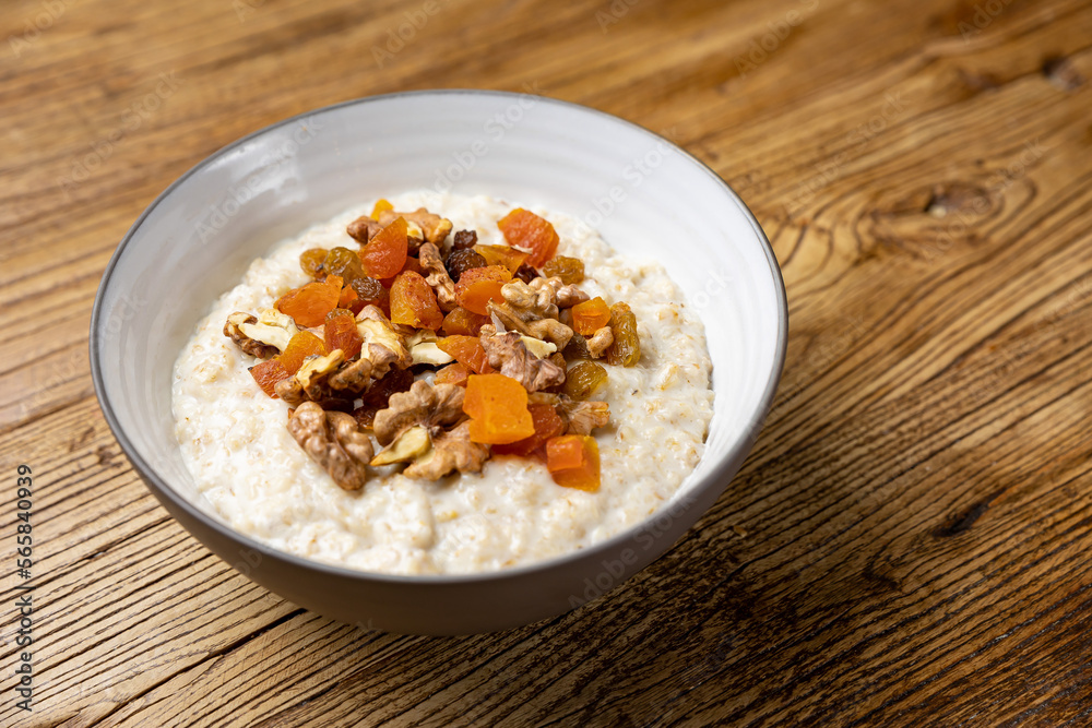 a delicious breakfast on a plate prepared in the restaurant. oatmeal with candied fruit and nuts
a delicious breakfast on a plate prepared in the restaurant. oatmeal with candied fruit and nuts