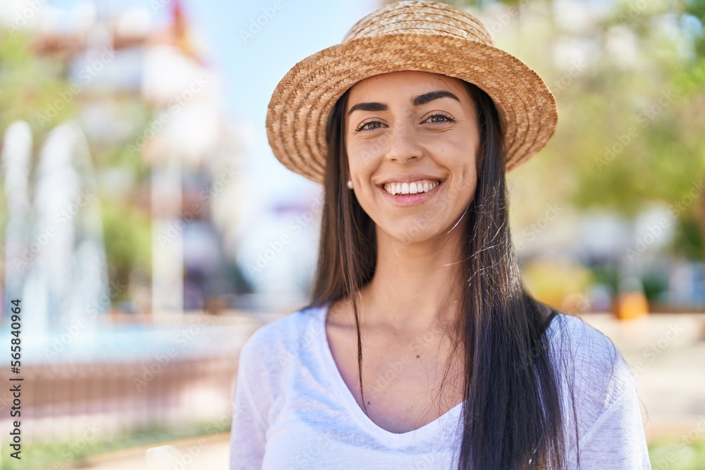 Young hispanic woman tourist smiling confident standing at park