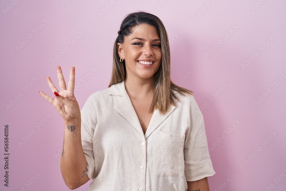 Blonde woman standing over pink background showing and pointing up with fingers number four while smiling confident and happy. Blonde woman standing over pink background showing and pointing up with fingers number four while smiling confident and happy.