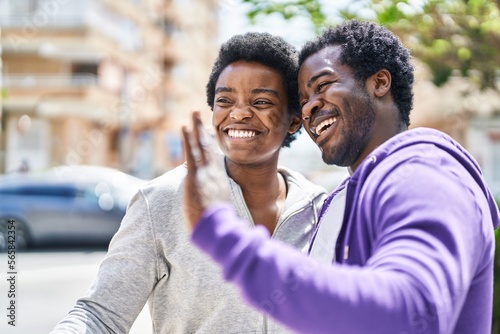 African american man and woman couple smiling confident standing together at street