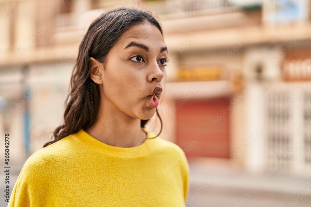 Young african american woman doing funny gesture with mouth at street Young african american woman doing funny gesture with mouth at street