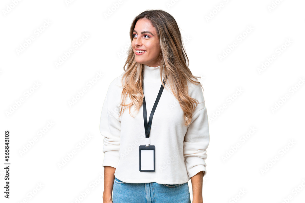 Young Uruguayan woman with ID card over isolated background looking to the side and smiling Young Uruguayan woman with ID card over isolated background looking to the side and smiling