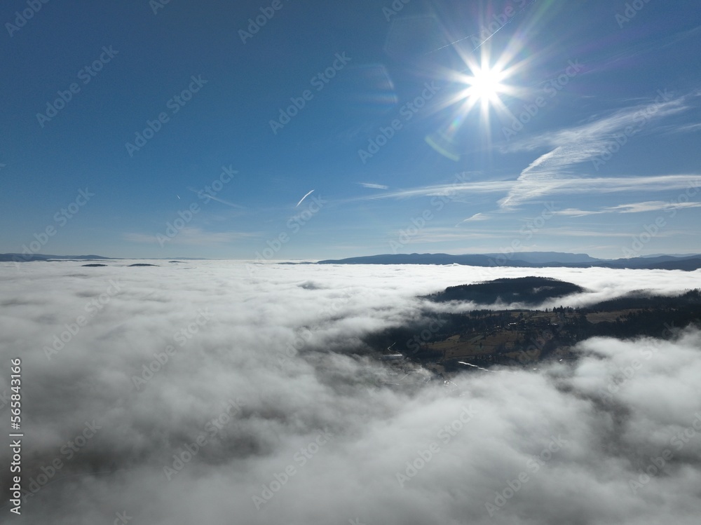 Aerial View. Flying over the high mountains in beautiful clouds. Aerial Drone camera shot. Air pollution clouds over Sarajevo in Bosnia and Herzegovina. Aerial View. Flying over the high mountains in beautiful clouds. Aerial Drone camera shot. Air pollution clouds over Sarajevo in Bosnia and Herzegovina.