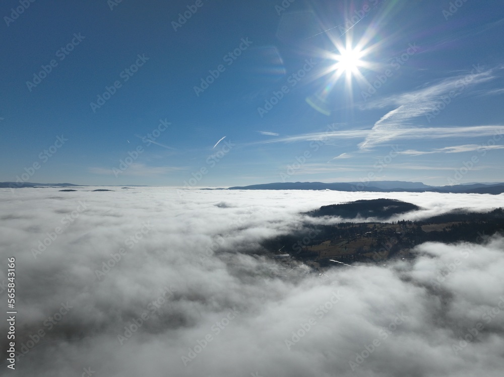 Aerial View. Flying over the high mountains in beautiful clouds. Aerial Drone camera shot. Air pollution clouds over Sarajevo in Bosnia and Herzegovina. 