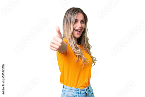 Fototapet Young Uruguayan woman over isolated background with thumbs up because something