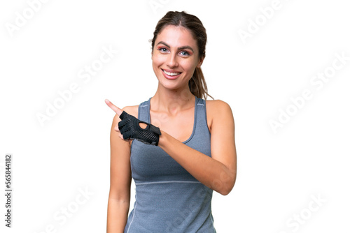 pretty Sport Uruguayan woman over isolated background pointing to the side to present a product