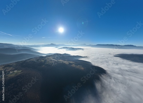 Aerial View. Flying over the high mountains in beautiful clouds. Aerial Drone camera shot. Air pollution clouds over Sarajevo in Bosnia and Herzegovina.  © .shock