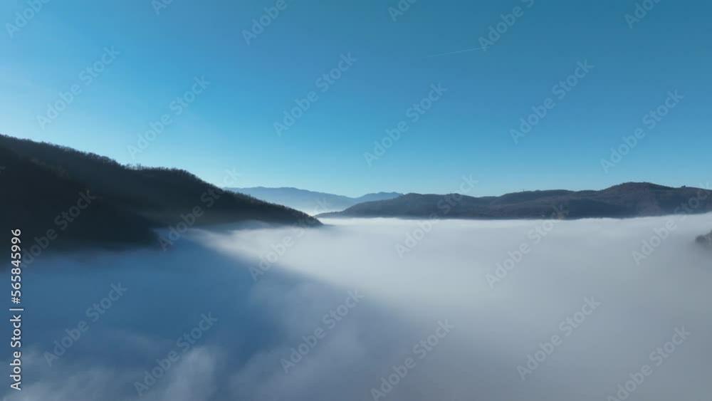 Aerial View. Flying over the high mountains in beautiful clouds. Aerial Drone camera shot. Air pollution clouds over Sarajevo in Bosnia and Herzegovina. Aerial View. Flying over the high mountains in beautiful clouds. Aerial Drone camera shot. Air pollution clouds over Sarajevo in Bosnia and Herzegovina.
