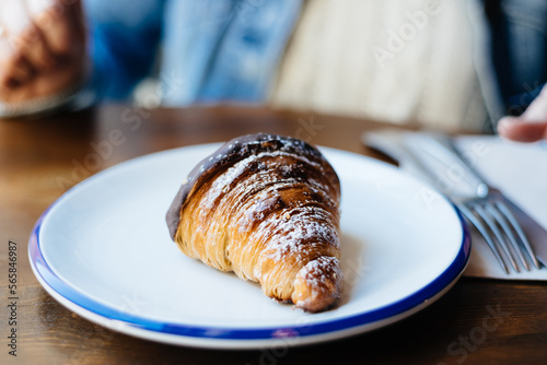 Close up of delicious fresh croissant on plate. Homemade croissant.