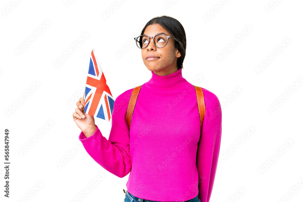 Young African American woman holding an United Kingdom flag over isolated chroma key background and looking up Young African American woman holding an United Kingdom flag over isolated chroma key background and looking up