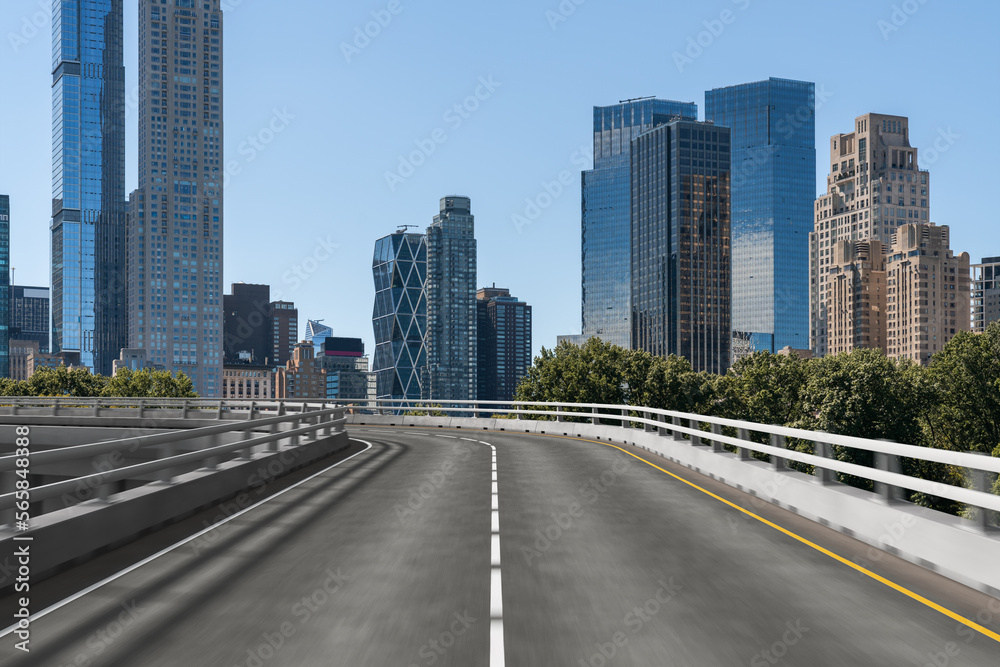 Empty urban asphalt road exterior with city buildings background. New modern highway concrete construction. Concept of way to success. Transportation logistic industry fast delivery. New York. USA. Empty urban asphalt road exterior with city buildings background. New modern highway concrete construction. Concept of way to success. Transportation logistic industry fast delivery. New York. USA.