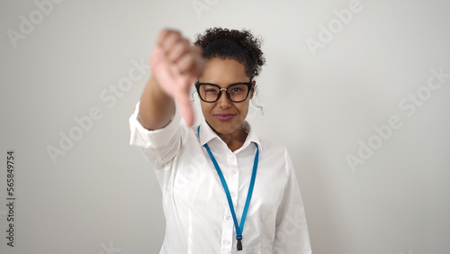 African american woman doing negative gesture with thumb down over isolated white background