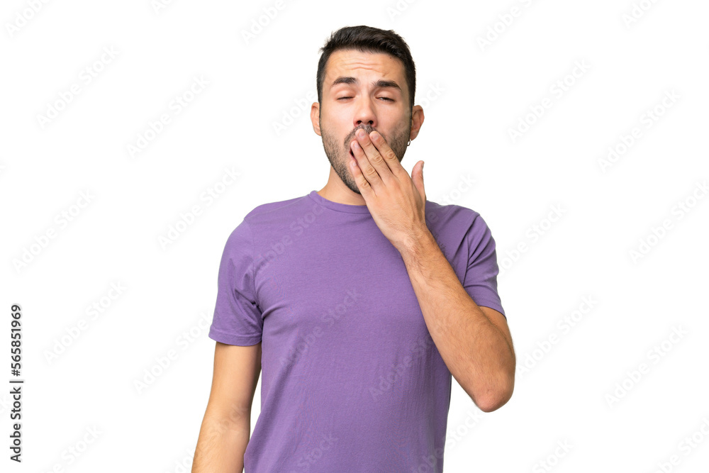 Young handsome caucasian man over isolated background yawning and covering wide open mouth with hand Young handsome caucasian man over isolated background yawning and covering wide open mouth with hand