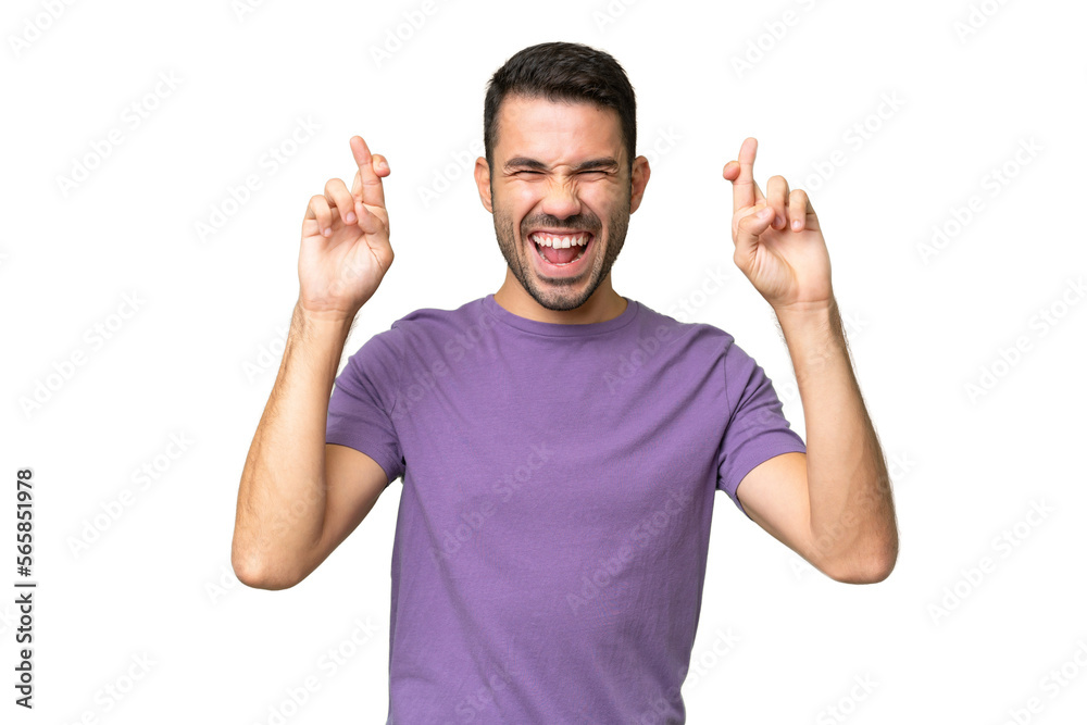 Young handsome caucasian man over isolated background with fingers crossing Young handsome caucasian man over isolated background with fingers crossing