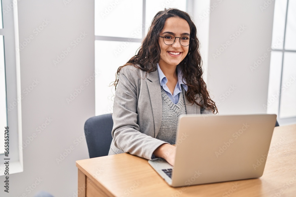 Young hispanic woman business worker using laptop working at office Young hispanic woman business worker using laptop working at office