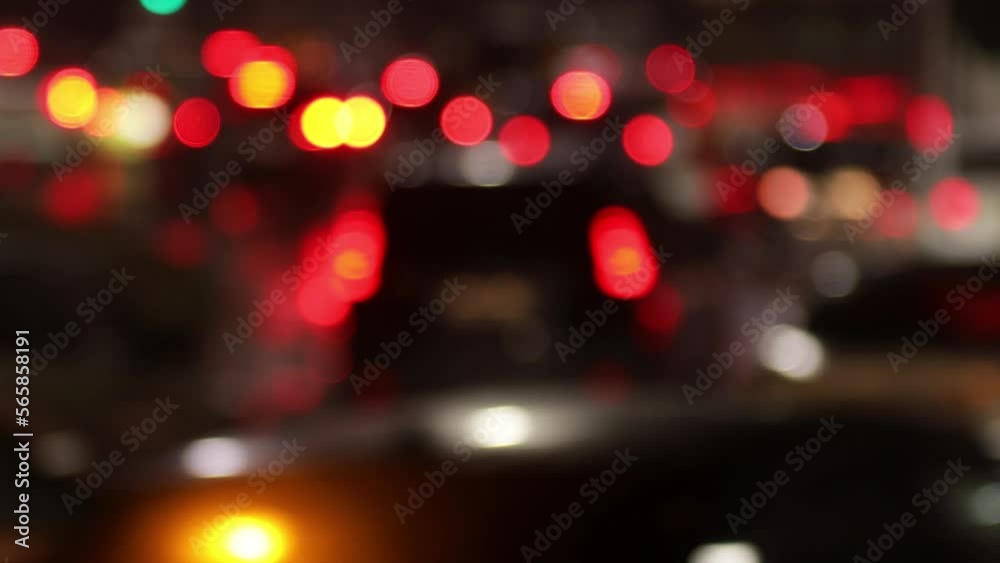 Blurred defocused video of evening car traffic in a big city. Cars in motion and standing in traffic jams. Long exposure exposure and headlight trails Blurred defocused video of evening car traffic in a big city. Cars in motion and standing in traffic jams. Long exposure exposure and headlight trails